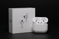 Apple AirPods with charging case on black background